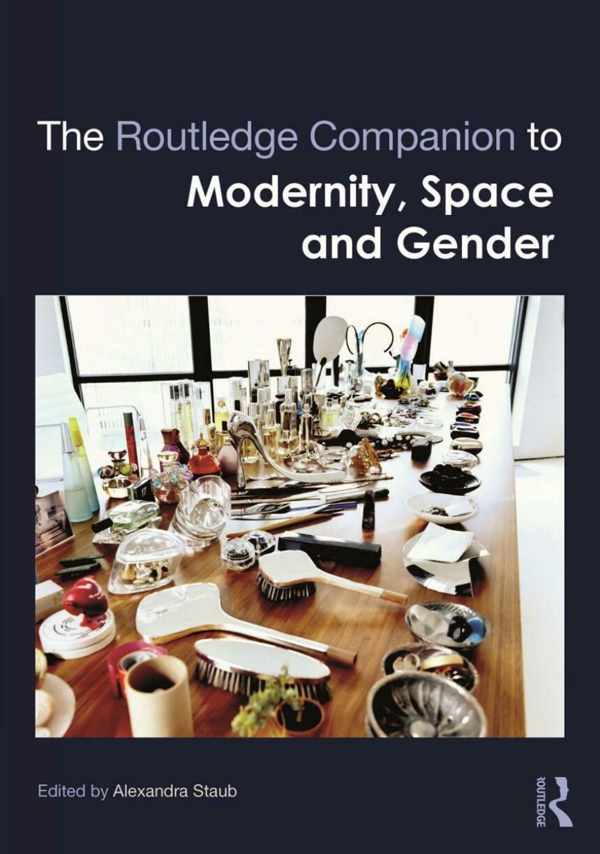 Dark blue book cover featuring a photo of a long wood table with a wide array of toiletries and hair styling tools.