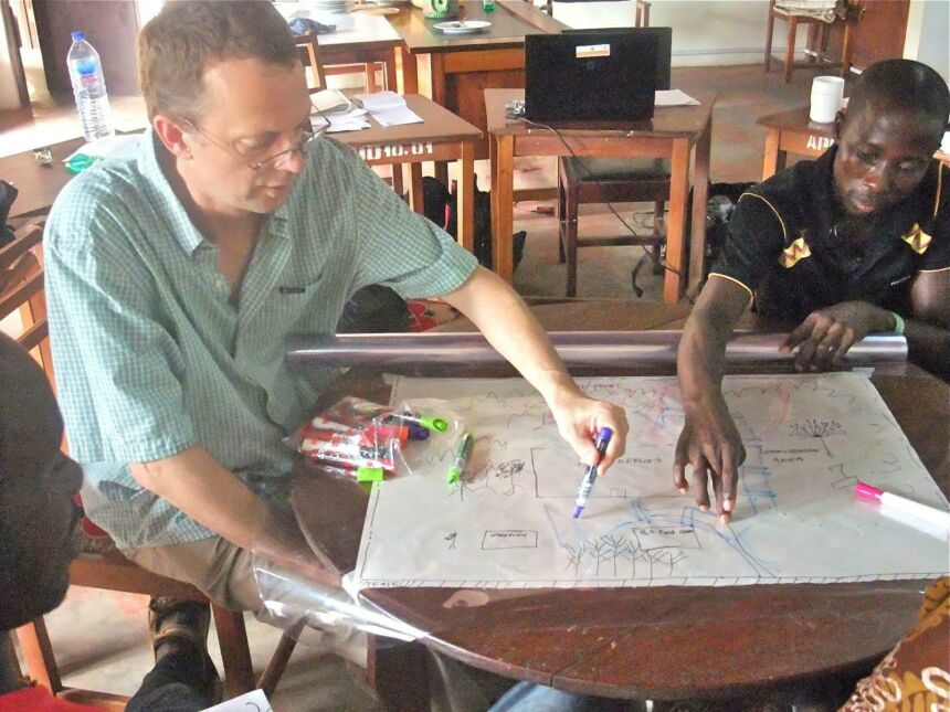 Ken Tamminga drawing layouts in a workshop with collaborators in Ghana.